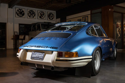 Blue Porsche car in a showroom setting