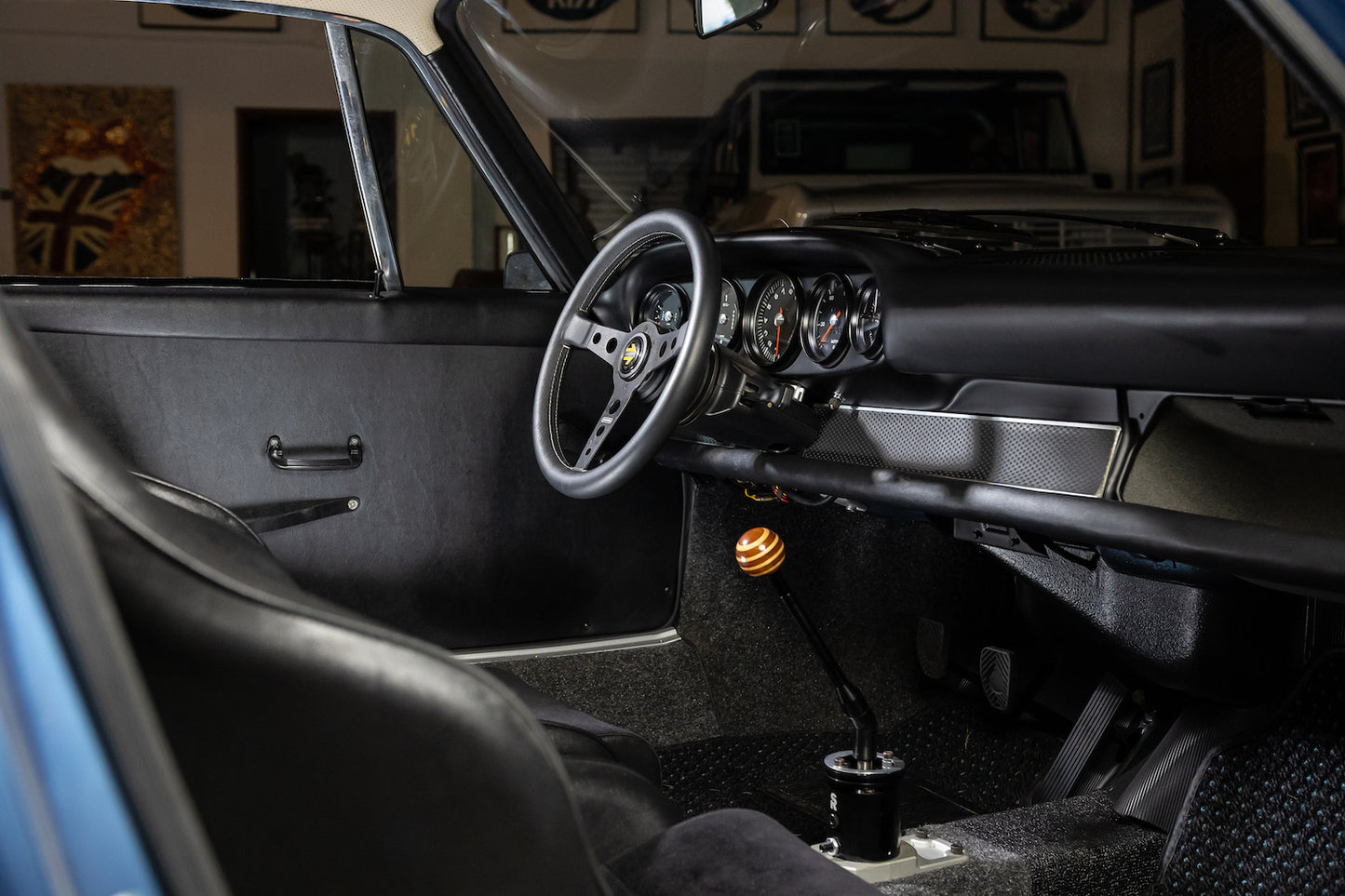 Close-up of a car's interior with steering wheel and dashboard.