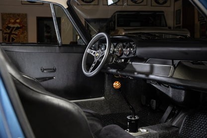 Close-up of a car's interior with steering wheel and dashboard.