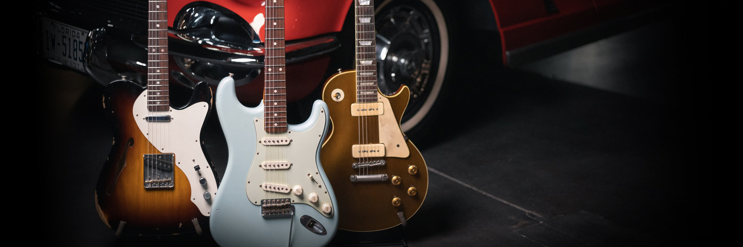 Electric Guitars in front of Corvette at Walt Grace Vintage