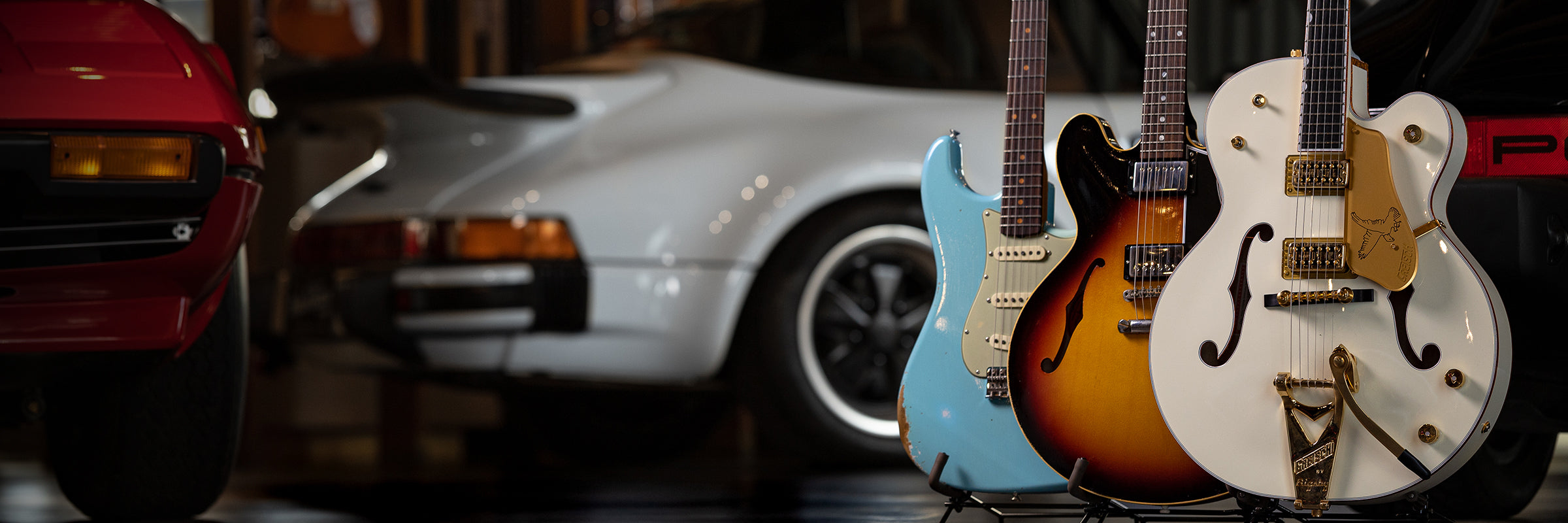Walt Grace Vintage Guitars in Gallery with Cars
