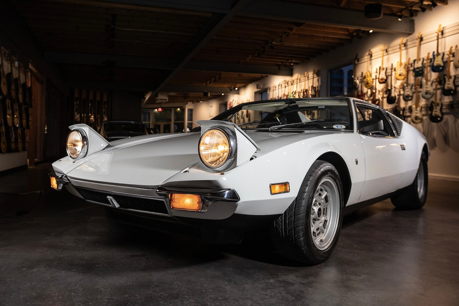 Vintage white sports car in a showroom setting