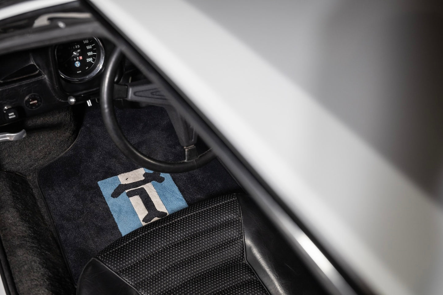 Car interior with a branded floor mat