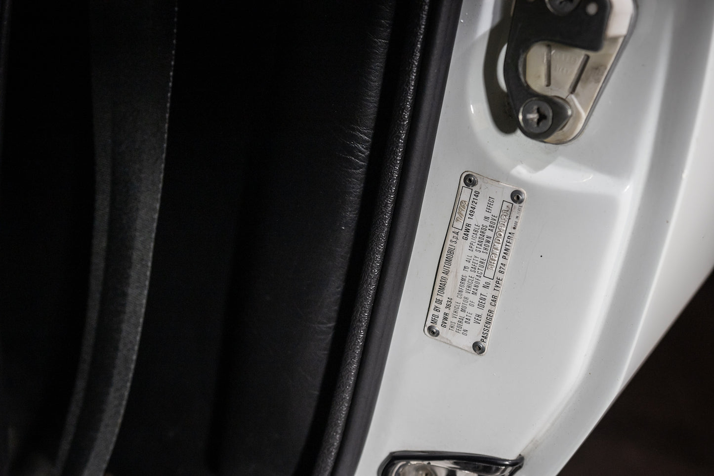 Close-up of a car's interior with a label on the door panel.