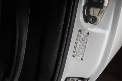 Close-up of a car's interior with a label on the door panel.