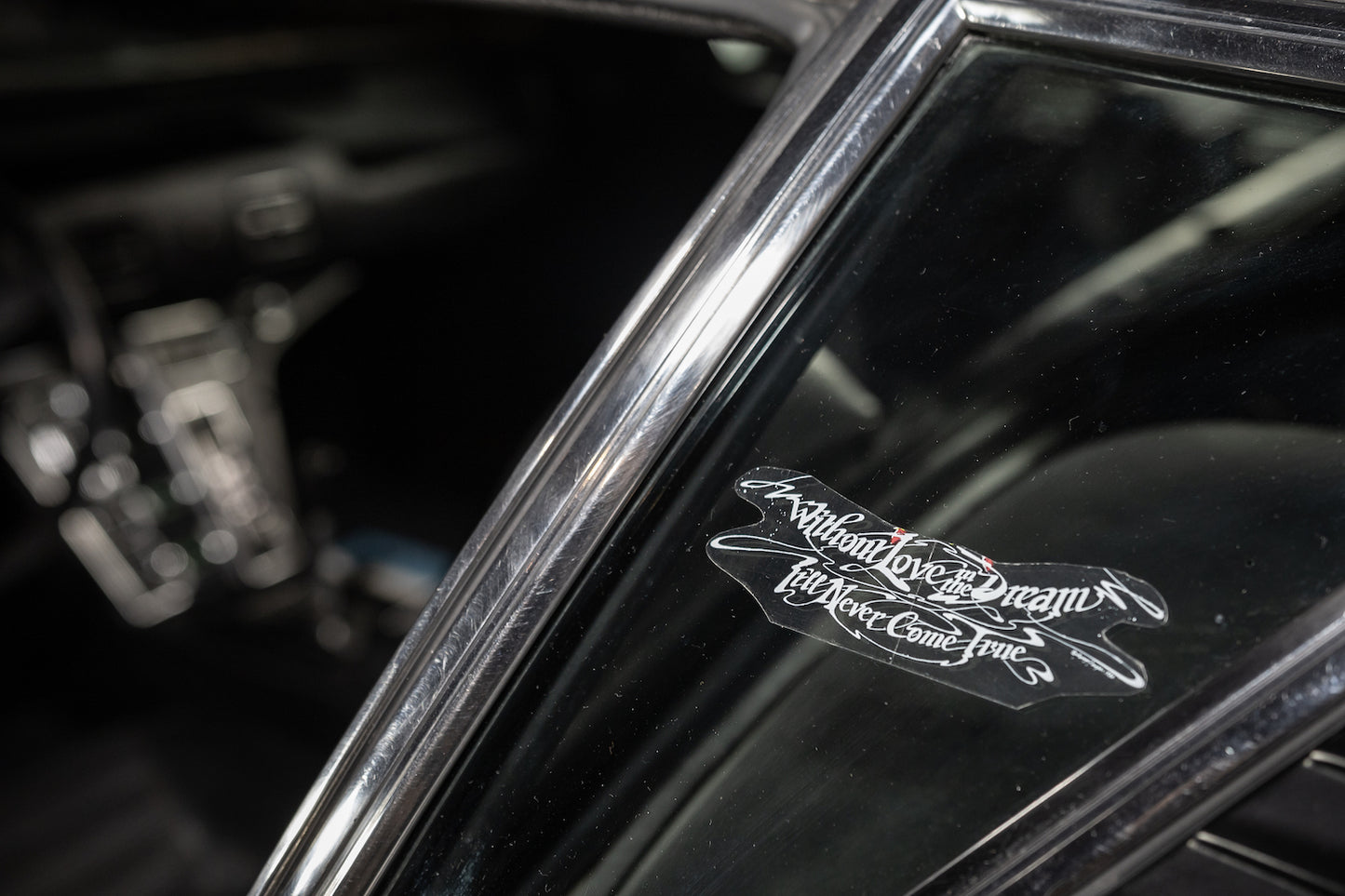 Close-up of a car's interior with a decorative emblem on the dashboard.