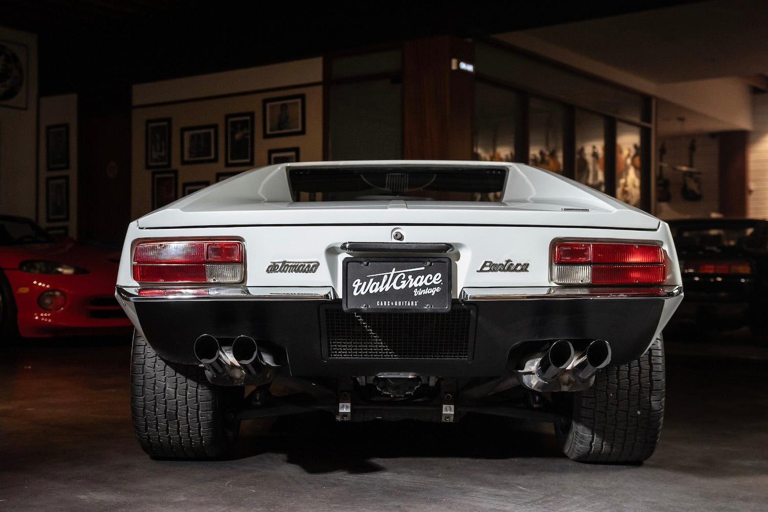 Back view of a luxury car with 'Wall Grace' branding in an indoor setting.