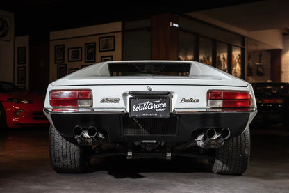 Back view of a luxury car with 'Wall Grace' branding in an indoor setting.