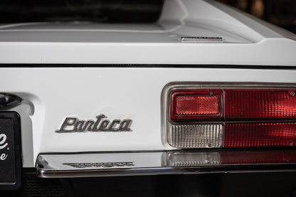 Close-up of a white car with 'Pantera' branding on the trunk.