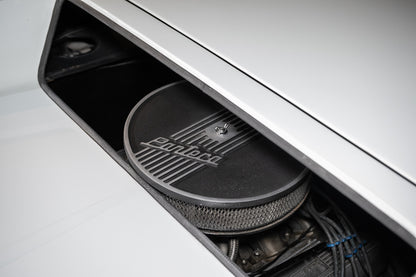 Close-up of a car's audio system with 'Ford' branding on a white background