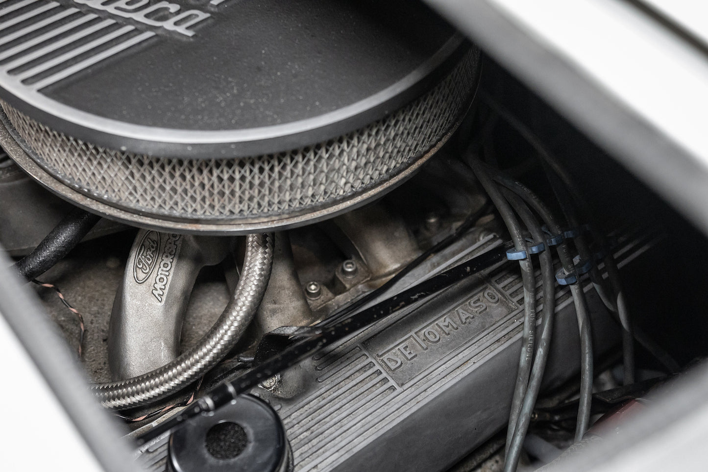 Close-up of a car engine with 'De Tomaso' branding