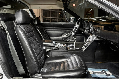 Close-up of a car's interior with leather seats and dashboard.