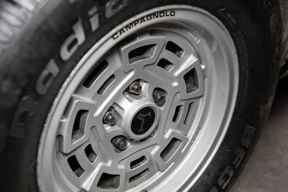 Close-up of a wheel with Campagnolo branding on a dark background