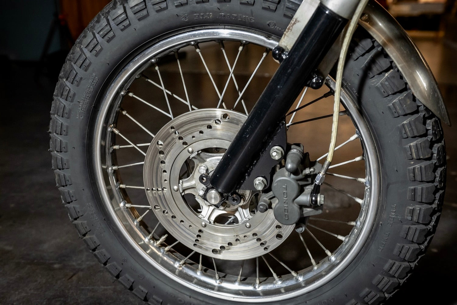 Close-up of a motorcycle wheel with tire and suspension