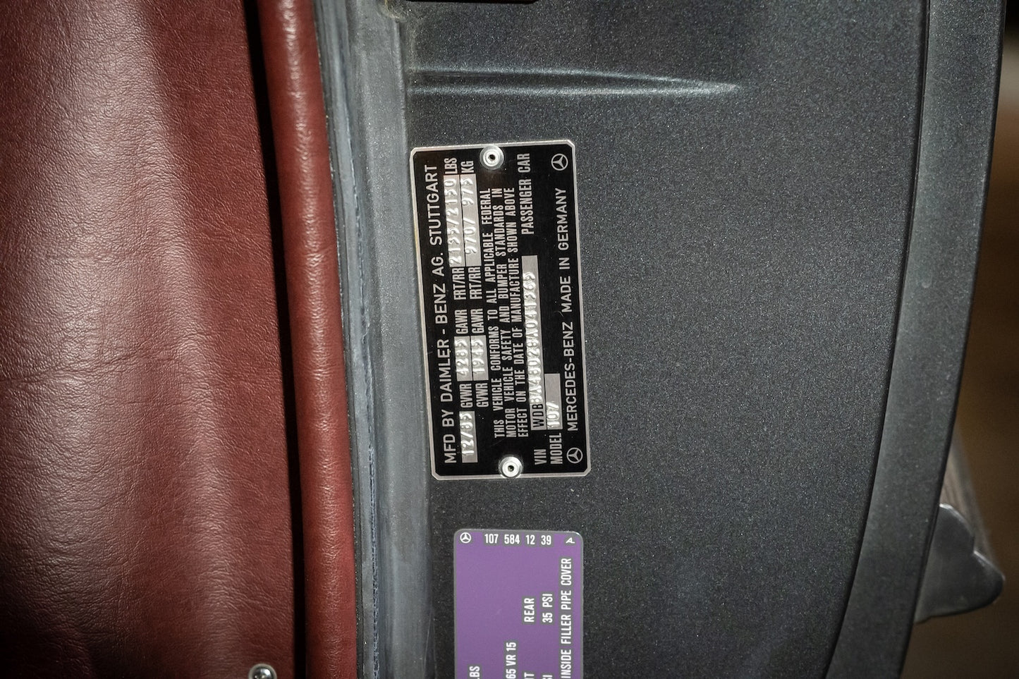 Close-up of a car door panel with a label on a vehicle interior.