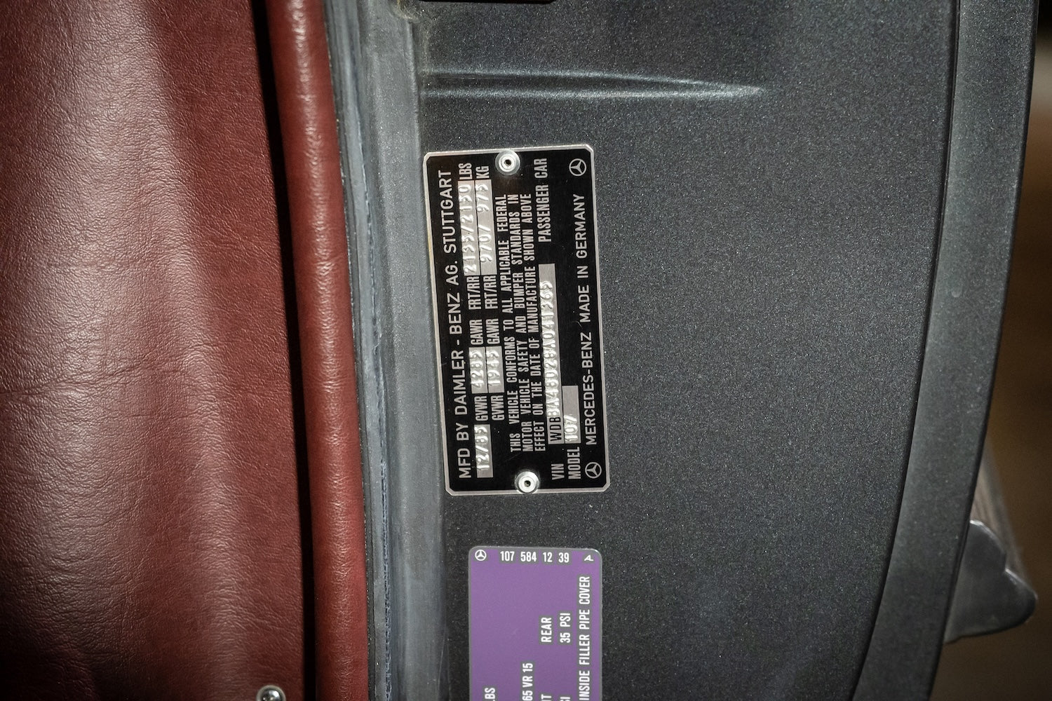Close-up of a car door panel with a label on a vehicle interior.