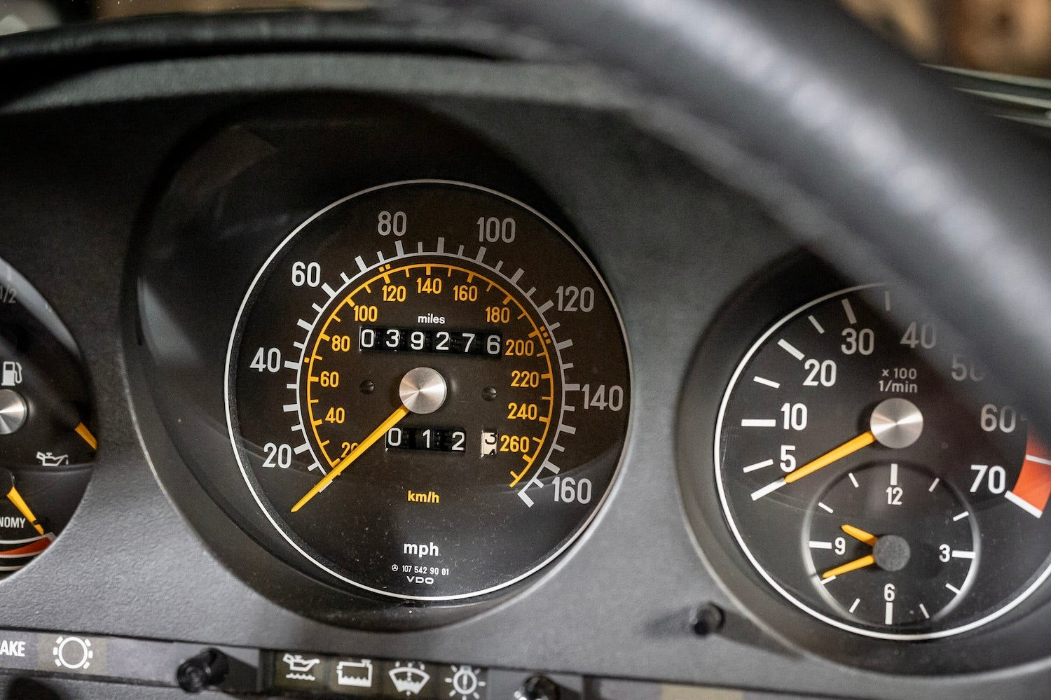 Close-up of a car dashboard with speedometer and tachometer