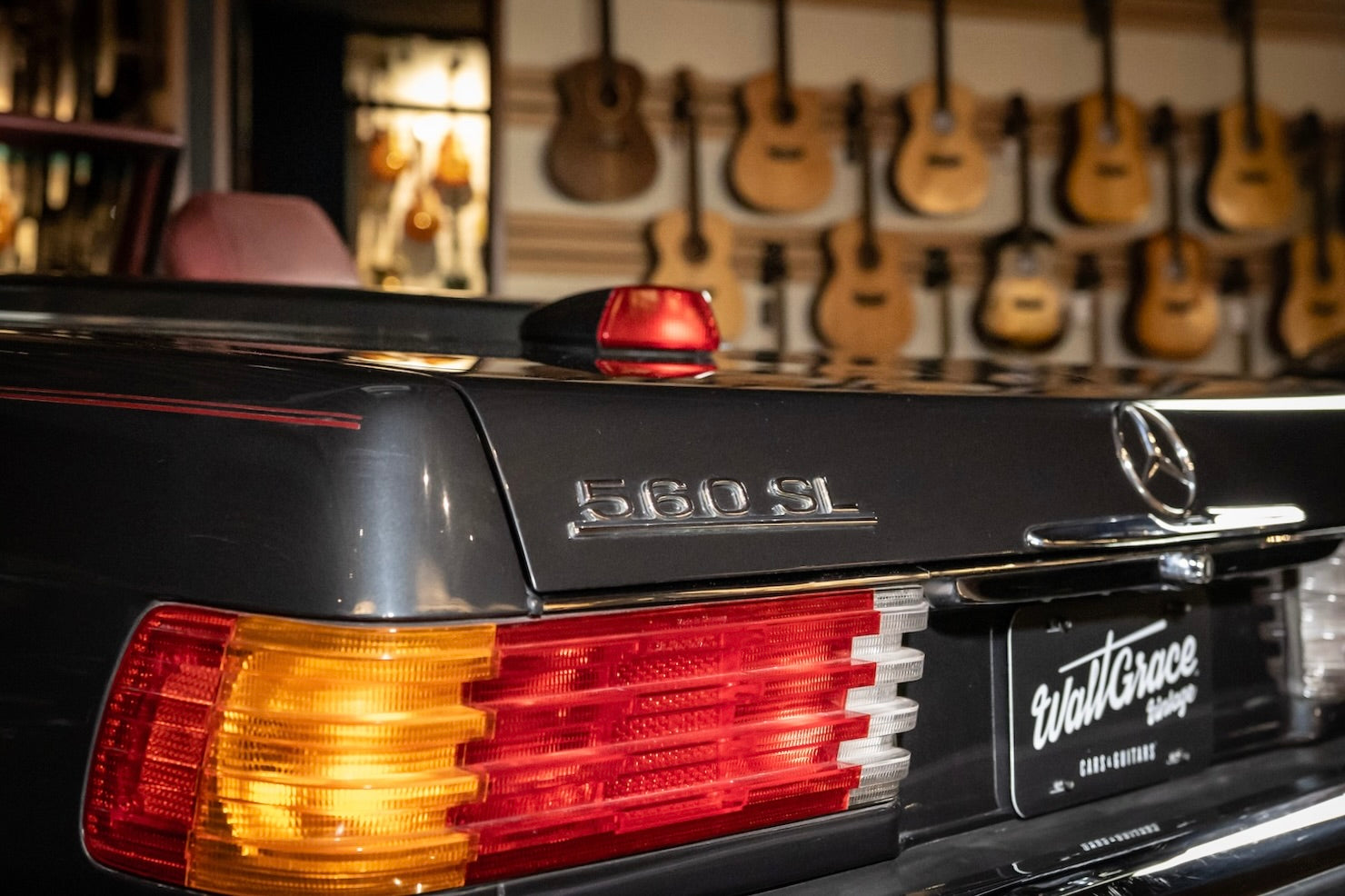 Mercedes-Benz 560 SL tail light with guitars in the background