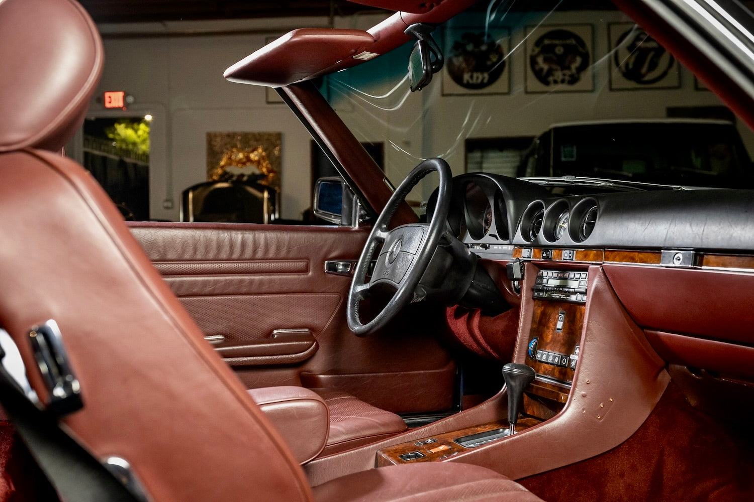 Luxurious car interior with brown leather seats and dashboard in a showroom setting.