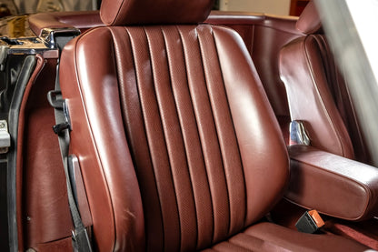 Brown leather car seat with visible stitching details