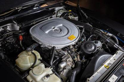 Car engine compartment with various components visible