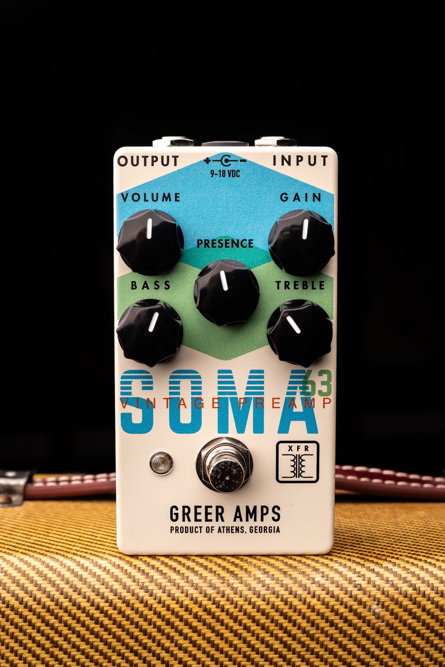 A vintage style guitar preamp pedal with knobs for volume, input, output, bass, treble, and presence, labeled 'SOMA '63' by Greer Amps.
