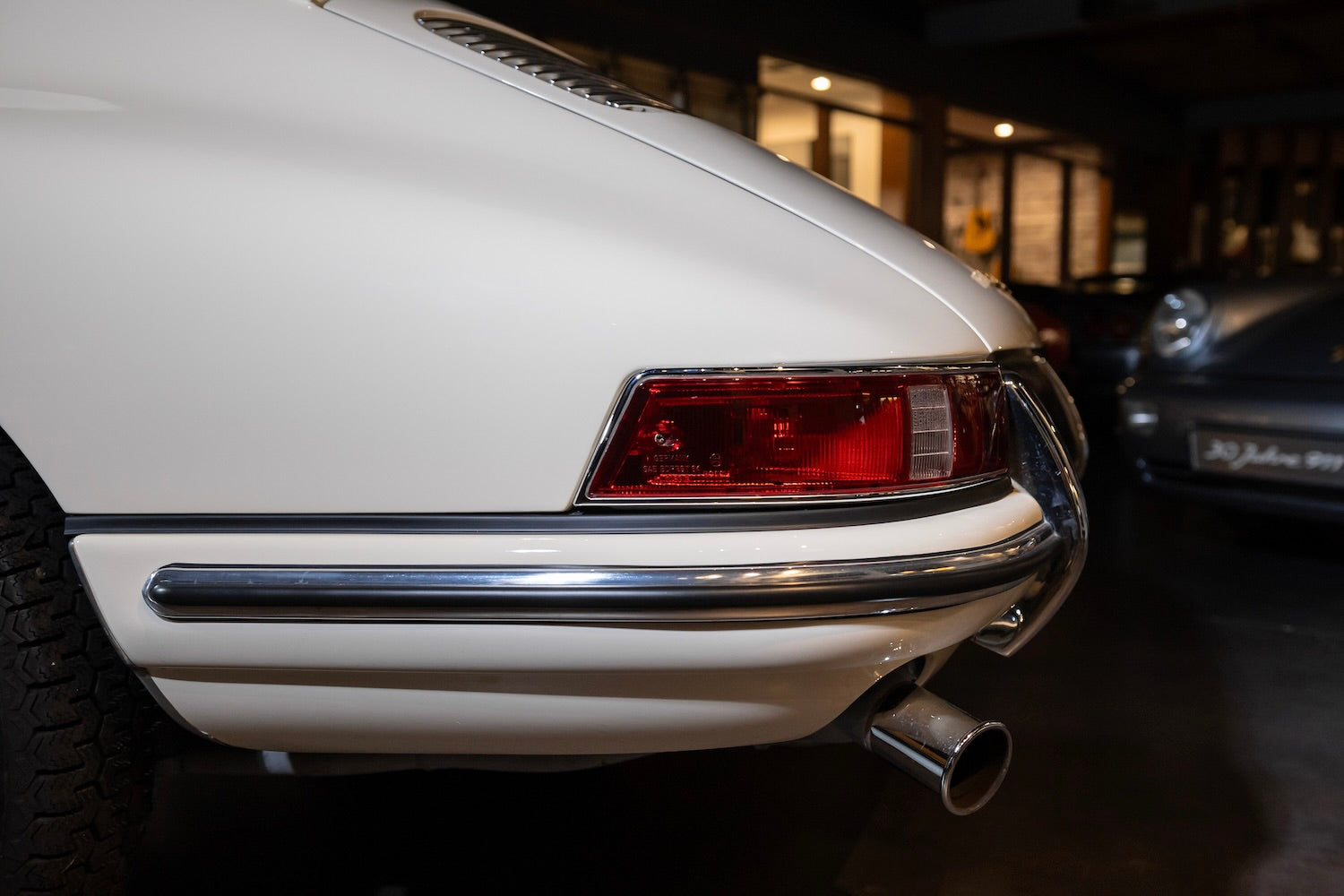 Close-up of a white car's rear end with a visible license plate.