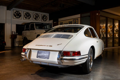 Vintage Porsche 911 car in a showroom setting