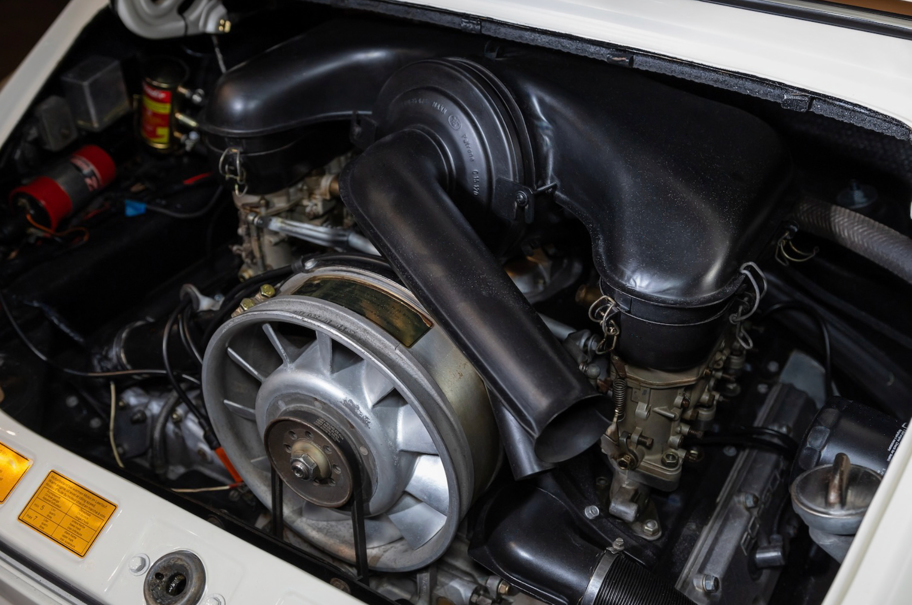Engine compartment of a vehicle with visible components.