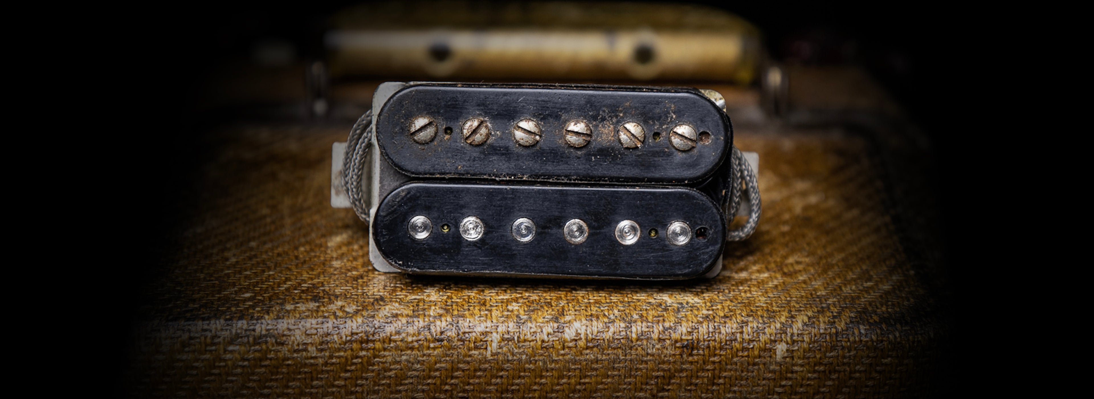Vintage Gibson PAF guitar pickup on tweed amp