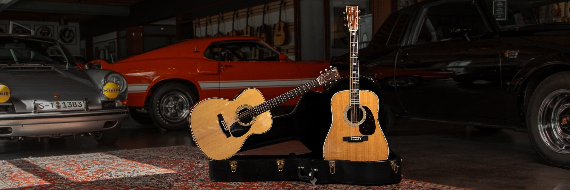 Marting acoustic guitars next to cars at Walt Grace Vintage