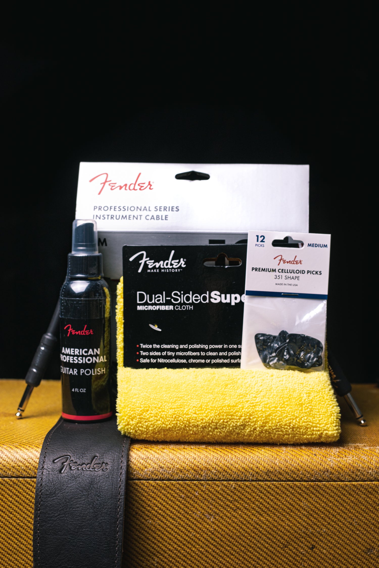 Fender Accessory Bundle on top of tweed amp